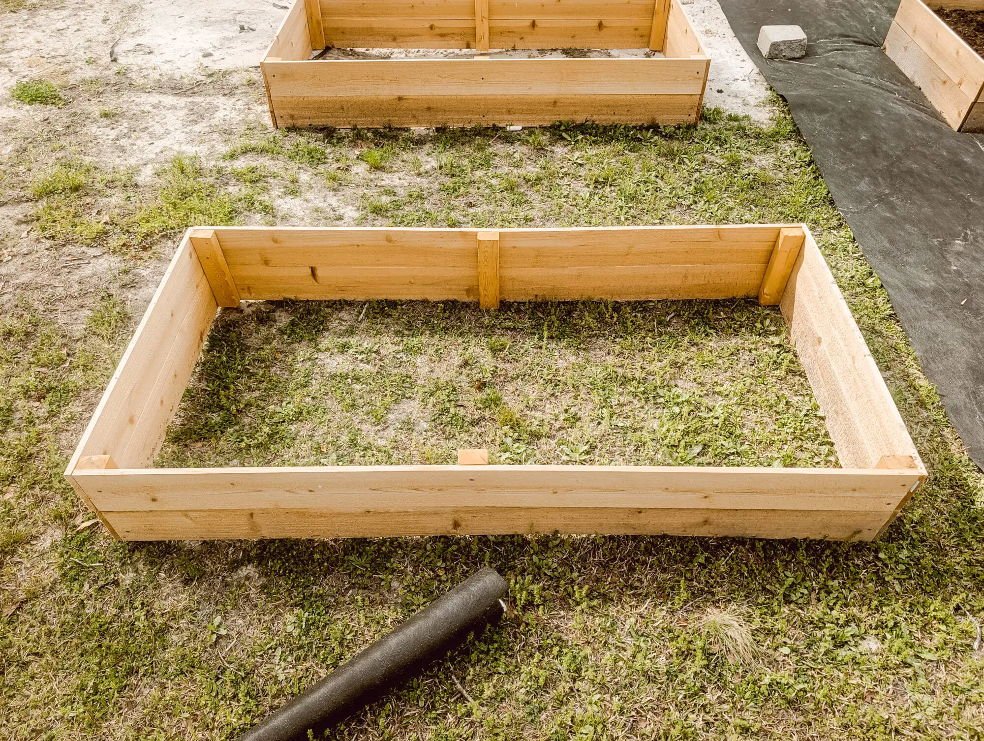 Finished 4×8 cedar raised bed on grass
